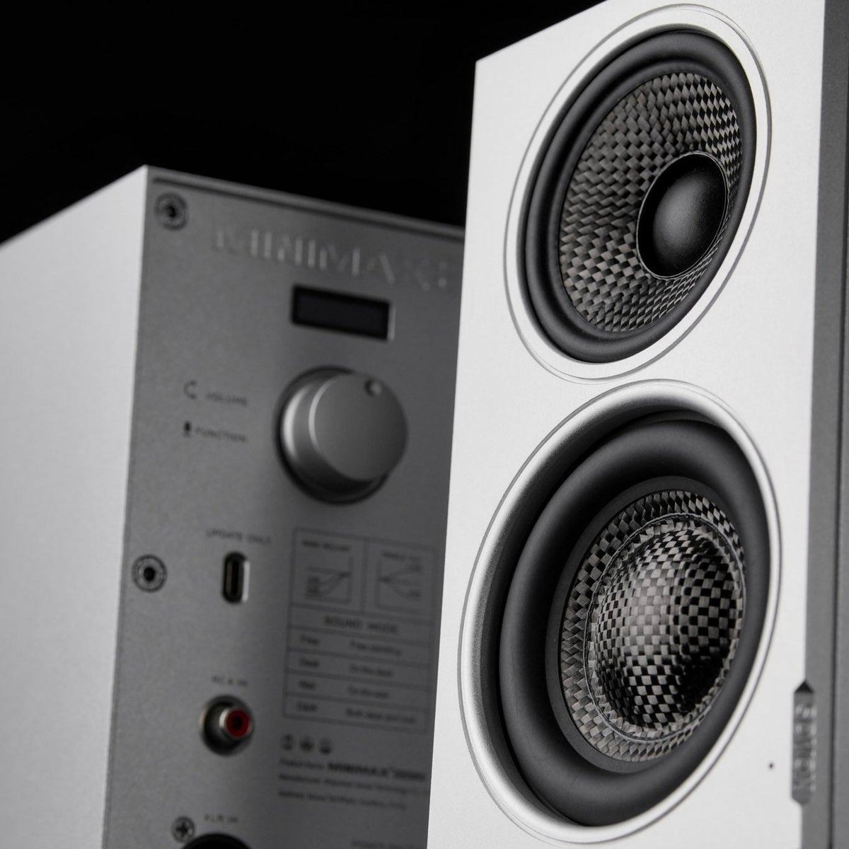 Close-up of the carbon-fiber coaxial and bass drivers on a silver SOVOX MiniMax3 Monitor