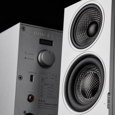 Close-up of the carbon-fiber coaxial and bass drivers on a silver SOVOX MiniMax3 Monitor